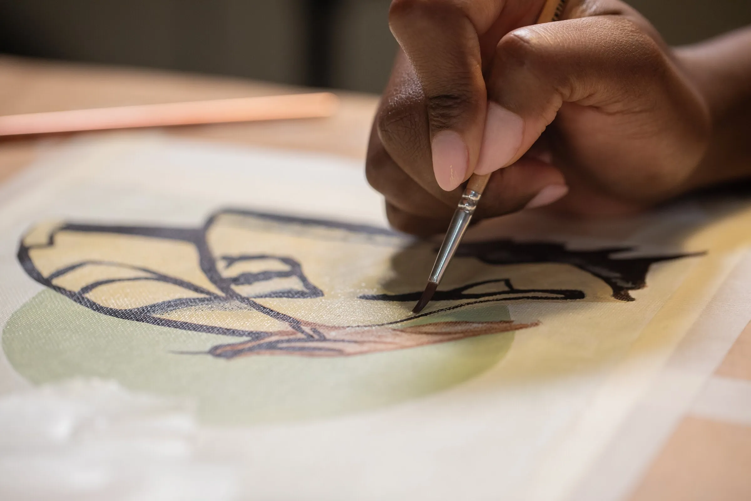 A young artist painting a botanical illustration in watercolour